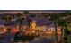 Exterior home view, with lights, landscaping, driveway, and garage at 11037 Clarion Ln, Las Vegas, NV 89134