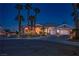 Charming single-story home with beautiful desert landscaping and a three-car garage at twilight at 11037 Clarion Ln, Las Vegas, NV 89134