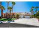 Charming single-story home with a well-manicured lawn, desert landscaping and a three-car garage at 11037 Clarion Ln, Las Vegas, NV 89134