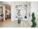 Elegant foyer with neutral tile flooring, statement glass door, and stylish decor creating a luxurious entrance at 11037 Clarion Ln, Las Vegas, NV 89134