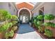 Inviting home entrance with mature landscaping and a covered walkway, providing a welcoming approach at 11037 Clarion Ln, Las Vegas, NV 89134