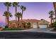 Charming home with a well-maintained front yard, mature palm trees, and a three-car garage for ample parking at 11037 Clarion Ln, Las Vegas, NV 89134
