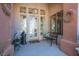 Inviting front porch featuring decorative glass door, chandelier, bench and decorative wall art at 11037 Clarion Ln, Las Vegas, NV 89134