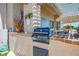Built-in outdoor grill with counter space under a covered patio in a desert landscape at 11037 Clarion Ln, Las Vegas, NV 89134