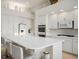 Bright, expansive kitchen with white cabinetry, marble countertops, an eat-in island, and modern appliances at 11037 Clarion Ln, Las Vegas, NV 89134
