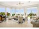 Bright and open living room with large windows, neutral furniture and backyard pool view at 11037 Clarion Ln, Las Vegas, NV 89134