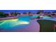 Backyard pool with putting green, rock features, and mood lighting at 11037 Clarion Ln, Las Vegas, NV 89134