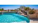 Beautiful pool with a rock waterfall feature and lush landscaping, perfect for outdoor relaxation at 11037 Clarion Ln, Las Vegas, NV 89134