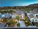 Expansive aerial view of an elegant home, showcasing its well-manicured landscaping, roof and neighborhood at 11573 Glowing Sunset Ln, Las Vegas, NV 89135