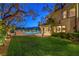 Beautiful backyard featuring a sparkling pool, lush lawn, and a charming outdoor dining area, perfect for entertaining at 11573 Glowing Sunset Ln, Las Vegas, NV 89135