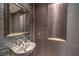 Elegant powder room with stylish sink, vanity, decorative mirror, and modern design at 11573 Glowing Sunset Ln, Las Vegas, NV 89135