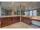 Bathroom featuring double vanities, ample mirrored storage, and tile flooring at 11573 Glowing Sunset Ln, Las Vegas, NV 89135