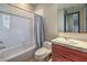 Bathroom with a tiled shower and bathtub and single sink vanity at 11573 Glowing Sunset Ln, Las Vegas, NV 89135