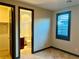 Bedroom leading to ensuite bathroom and closet with tile floors and neutral walls at 11573 Glowing Sunset Ln, Las Vegas, NV 89135