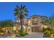 Elegant two-story home featuring a lush landscaped yard with mature trees and a private balcony at 11573 Glowing Sunset Ln, Las Vegas, NV 89135