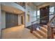 Grand foyer featuring a curved staircase and an open floor plan with large windows at 11573 Glowing Sunset Ln, Las Vegas, NV 89135