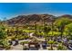Picturesque golf course view with lush greenery, mature trees, and mountain views in a luxurious community setting at 11573 Glowing Sunset Ln, Las Vegas, NV 89135
