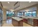 Bright kitchen featuring a central island, farmhouse sink, stainless steel appliances, and beautiful backyard views at 11573 Glowing Sunset Ln, Las Vegas, NV 89135