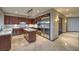 Modern kitchen with stainless steel appliances, wooden cabinets, and tile flooring at 11573 Glowing Sunset Ln, Las Vegas, NV 89135