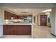 Spacious kitchen with wooden cabinetry, stainless steel appliances, and a large center island at 11573 Glowing Sunset Ln, Las Vegas, NV 89135