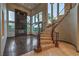 Bright living room featuring a spiral staircase, large windows, and hardwood floors at 11573 Glowing Sunset Ln, Las Vegas, NV 89135