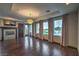 Living room with fireplace, media center, dark hardwood floors and backyard views at 11573 Glowing Sunset Ln, Las Vegas, NV 89135