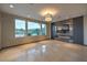 Open-concept living space featuring an entertainment center with fireplace and backyard views at 11573 Glowing Sunset Ln, Las Vegas, NV 89135