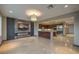 Open-concept living space featuring a sleek fireplace, built-in entertainment center and modern lighting at 11573 Glowing Sunset Ln, Las Vegas, NV 89135