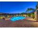 Inviting pool with a separate spa, set against a backdrop of desert landscape and a clear evening sky at 11573 Glowing Sunset Ln, Las Vegas, NV 89135