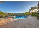 Inviting outdoor pool with desert views, surrounded by lush landscaping and brick pavers at 11573 Glowing Sunset Ln, Las Vegas, NV 89135