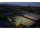 Aerial view of tennis and pickleball courts in a well-maintained community with mature landscaping at 11573 Glowing Sunset Ln, Las Vegas, NV 89135
