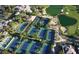Aerial view of community tennis courts with lush landscaping and mature palm trees at 11573 Glowing Sunset Ln, Las Vegas, NV 89135
