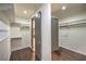 Walk-in closet with dark hardwood floors and custom shelving at 11573 Glowing Sunset Ln, Las Vegas, NV 89135