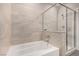 Bathroom featuring tile surround, a bathtub, a shower, and a glass enclosure at 11870 Tevare Ln # 1085, Las Vegas, NV 89138