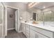 Bathroom featuring a double sink vanity, modern fixtures, and glass shower enclosure at 11870 Tevare Ln # 1085, Las Vegas, NV 89138