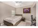 Comfortable bedroom featuring neutral paint, a bed with storage drawers, and a ceiling fan at 11870 Tevare Ln # 1085, Las Vegas, NV 89138