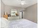 Bedroom features a ceiling fan, neutral paint, and large dresser with mirror and photos at 11870 Tevare Ln # 1085, Las Vegas, NV 89138