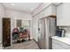 Well-organized kitchen features stainless steel appliances, white cabinetry, and countertop appliances displayed on a shelving unit at 11870 Tevare Ln # 1085, Las Vegas, NV 89138