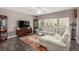 Spacious living room featuring a plush white sofa, rug, and natural light at 11870 Tevare Ln # 1085, Las Vegas, NV 89138