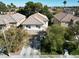 Beautiful suburban home with a tile roof, mature trees, and well-maintained landscaping at 1348 Calle Montery St, Las Vegas, NV 89117