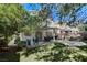 Lush backyard featuring a covered patio, dining furniture, and manicured landscaping at 1348 Calle Montery St, Las Vegas, NV 89117