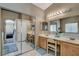 Bathroom featuring dual sinks, white countertops and tile floor, and mirrored sliding closet at 1348 Calle Montery St, Las Vegas, NV 89117