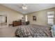 Spacious bedroom featuring a ceiling fan, plush carpeting, and bright natural light at 1348 Calle Montery St, Las Vegas, NV 89117