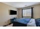 Comfortable bedroom with a flat screen TV and natural light from the window at 1348 Calle Montery St, Las Vegas, NV 89117