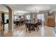The dining area features a large mirror, chandelier, and wood floors at 1348 Calle Montery St, Las Vegas, NV 89117