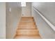 Wooden staircase with a white handrail, blending safety with a touch of elegance at 1348 Calle Montery St, Las Vegas, NV 89117