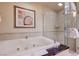 Relaxing bathroom showcasing a large soaking tub and glass-enclosed shower with modern fixtures at 135 E Harmon Ave # 3215, Las Vegas, NV 89109