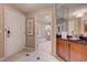 Hallway with access to the bathroom and entry door, featuring modern tile flooring and stylish decor at 135 E Harmon Ave # 3215, Las Vegas, NV 89109