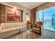 Inviting living room with plush seating, stylish decor, and stunning city views from the large windows at 135 E Harmon Ave # 3215, Las Vegas, NV 89109