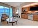 Cozy living space with a kitchenette, table, chairs, and expansive windows offering great city views at 135 E Harmon Ave # 3215, Las Vegas, NV 89109